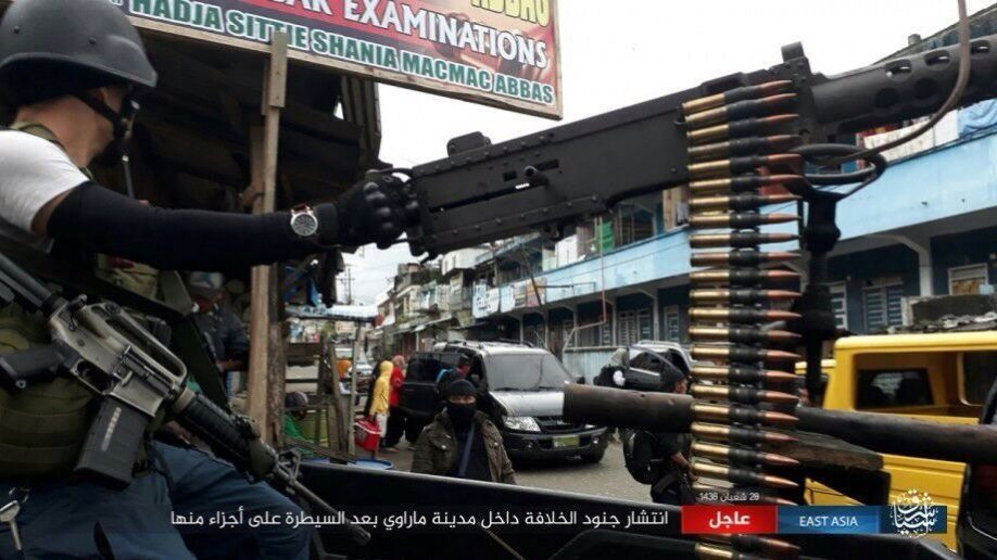 Click to enlarge ISIS fighters drive their trucks and automatic weapons through the conquered city