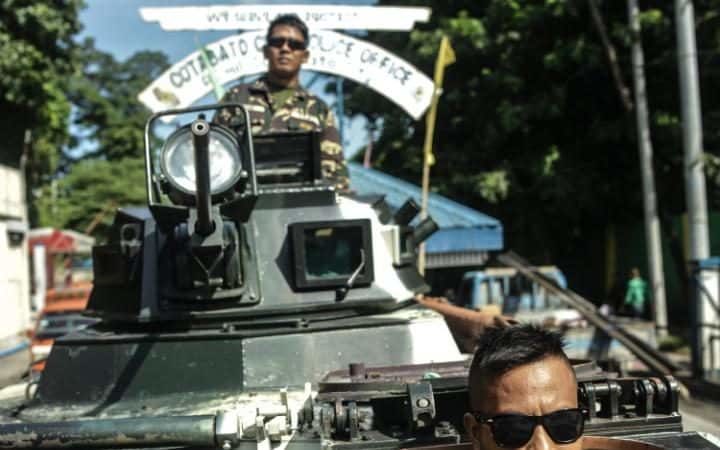 Click to enlarge Filipino soldiers man a military armoured personnel carrier on a street following President Rodrigo Duterte's declaration of Martial law in Cotabato City, Mindanao Island, southern Philippines