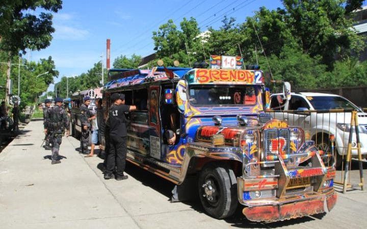 Click to enlarge Filipino soldiers check a vehicle with evacuating residents