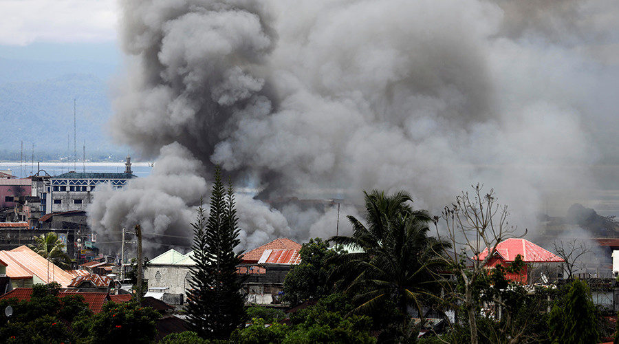 Smoke rises in the residential neighbourhood of Marawi City in southern Philippines