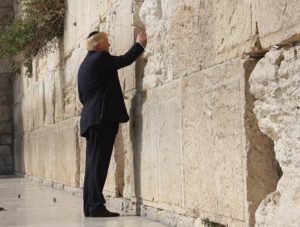Click to enlarge Donald Trump places a prayer in-between the stone blocks of the Western Wall