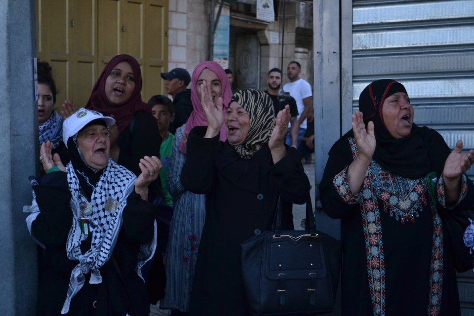 large crowd of Palestinians had gathered, chanting and waving flags