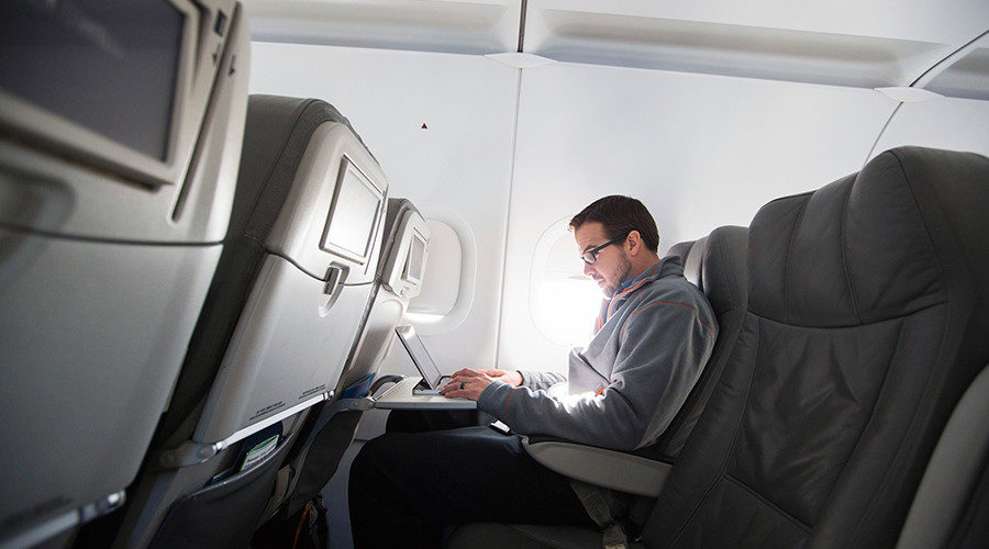 guy on laptop on plane