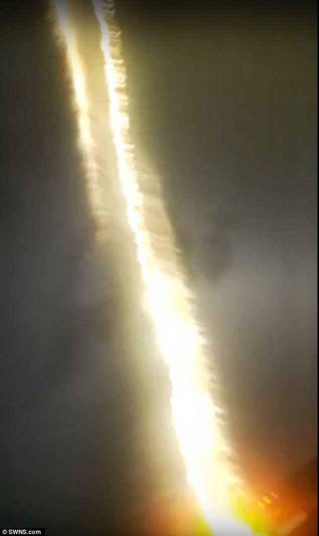Click to enlarge A close-up shot of the footage shows the moment the lightning bolt hit the house in Mutley, Devon, setting it ablaze. It was captured by student Alex Sawyer who described it as like 'fire raining down from the sky'