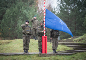 The NATO flag is raised during the opening ceremony for Exercise Steadfast Jazz in Poland