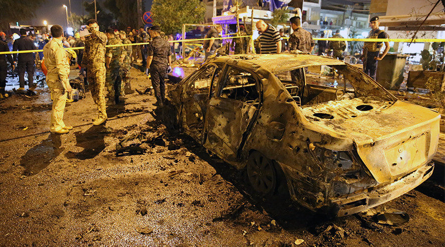 Click to enlarge People gather around the incident site after a car-bomb attack, Karrada district, Baghdad