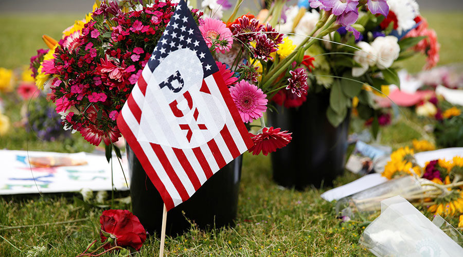 Click to enlarge A flag at a makeshift memorial for two men who were killed while trying to stop an Islamophobic attack against two women in Portland