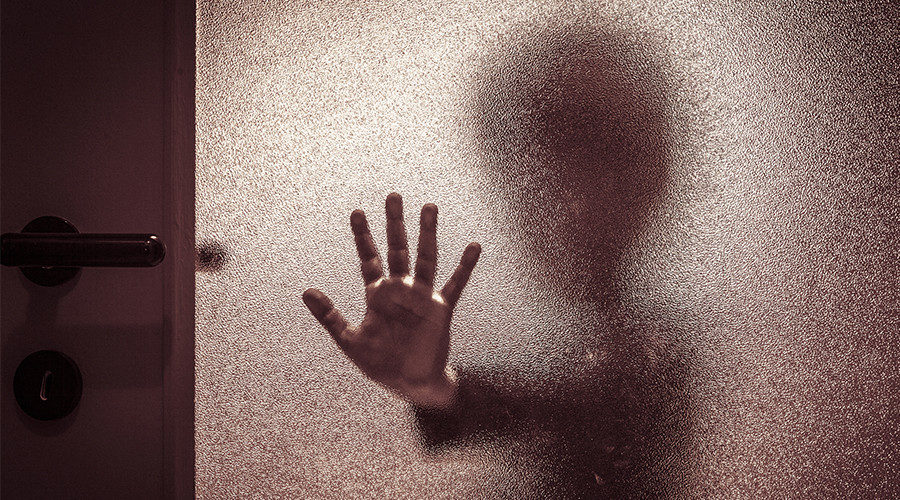 child pressing on shower door