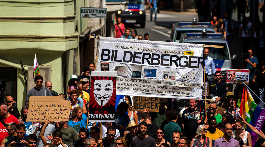 Protesters take part in a demonstration against the Bilderberg conference