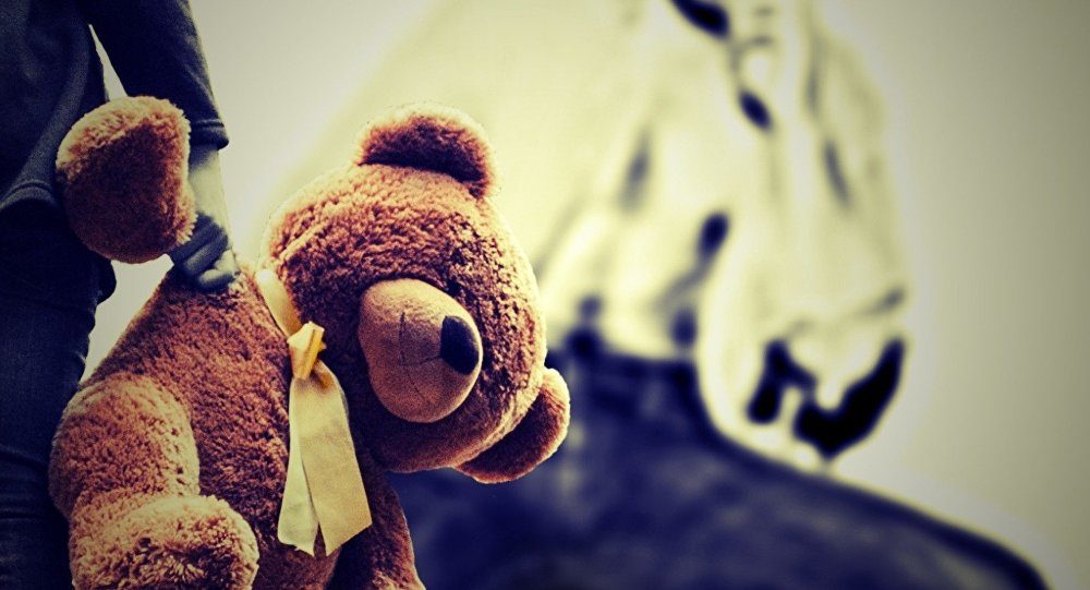 child holding teddy bear