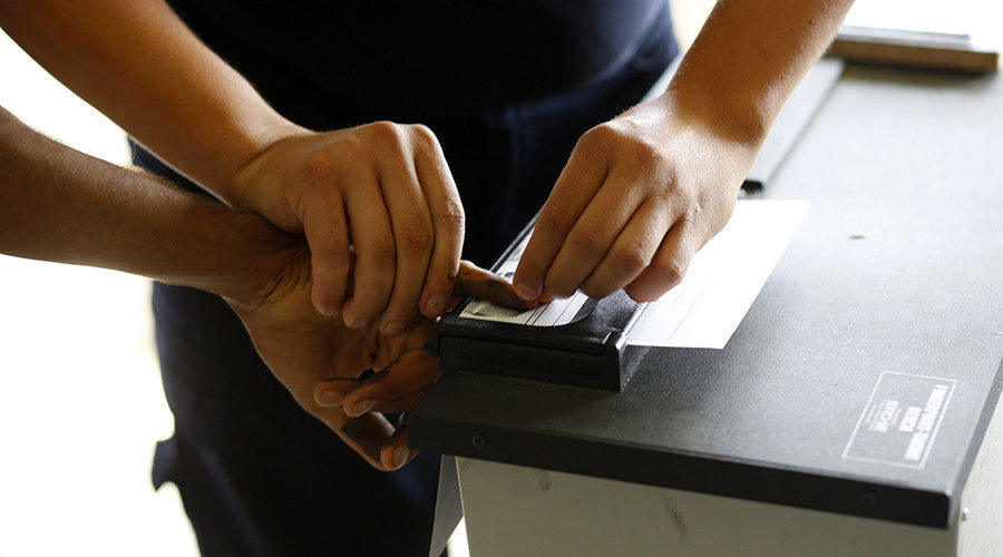 Click to enlarge person being fingerprinted