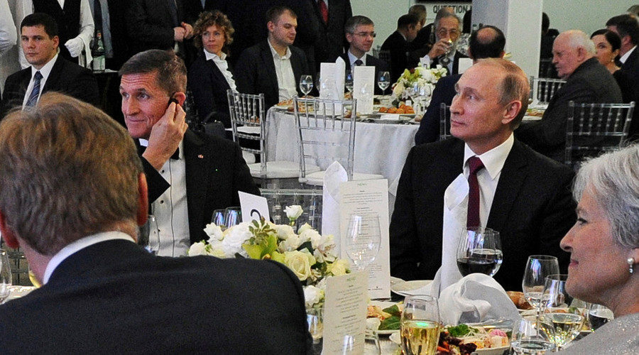 Click to enlarge Russian President Vladimir Putin (R) sits next to retired U.S. Army Lieutenant General Michael Flynn (L), December 10, 2015.