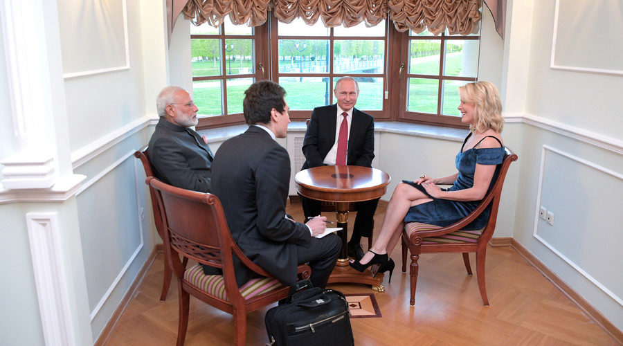 Russian President Vladimir Putin and Indian Prime Minister Narendra Modi talk to US journalist and NBC anchor Megyn Kelly (R), June 1, 2017.