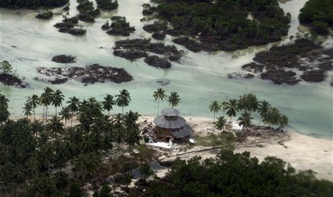 damaged building in a village flattened by Monday's earthquake triggered tsunami