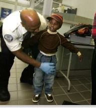 TSA official patting down a child