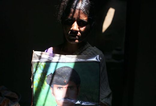 Indian widow with picture of husband