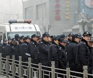 Click to enlarge Police officers stand guard-China