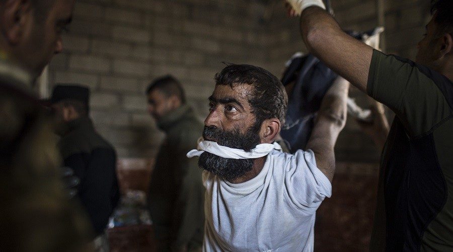 Iraqi soldiers torturing a man