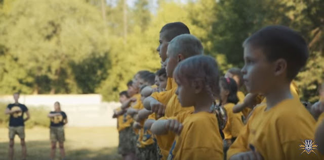 Click to enlarge young children, dressed in yellow Azovets uniforms