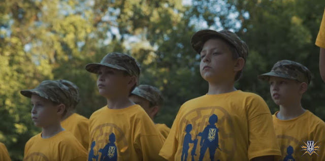 Click to enlarge young children, dressed in yellow Azovets uniforms