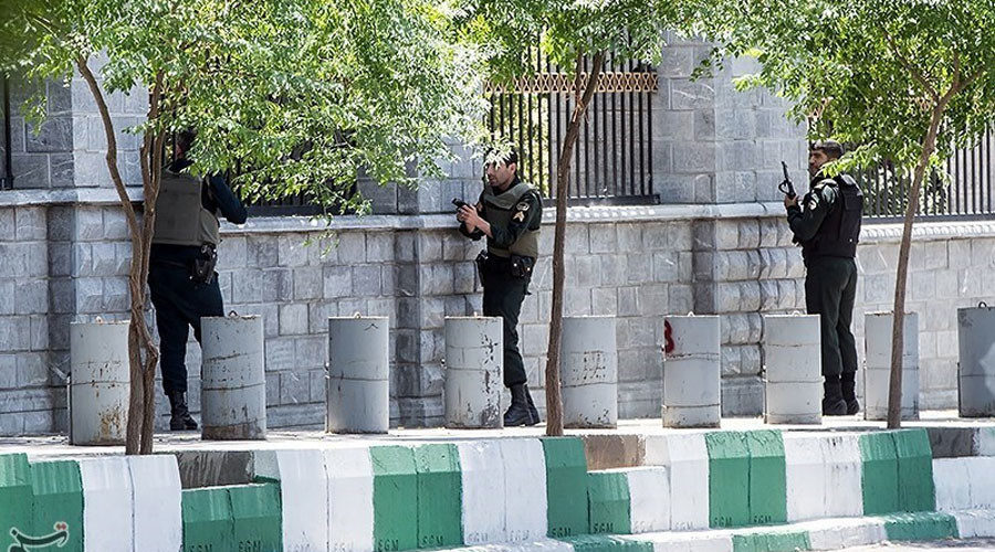 Members of Iranian forces run for cover during an attack