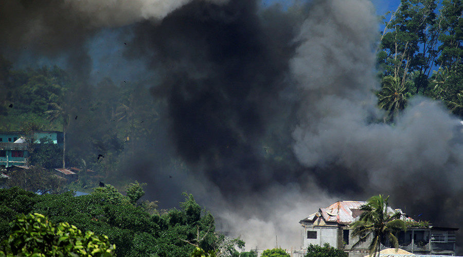 Black smoke comes from a burning building in Marawi City