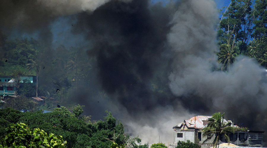 Click to enlarge Black smoke comes from a burning building in Marawi City