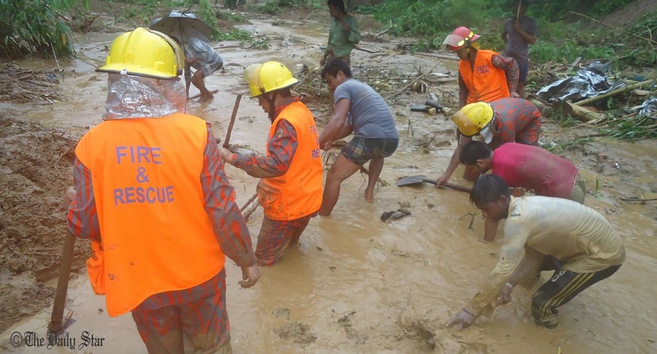 Rescuers looking for a missing mother- daughter duo after the landslide at Lemujiri Aga area in Bandarban on June 13, 2017. 