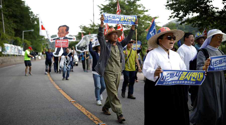 Click to enlarge villager holding up a banner that reads