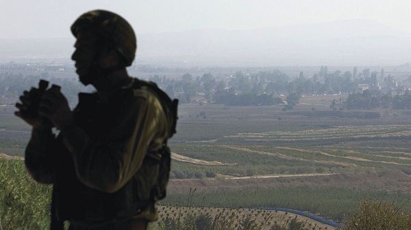An Israeli soldier watching over Syria's Quneitra province