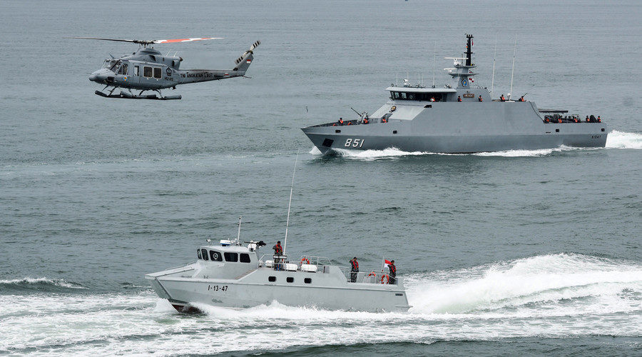 Indonesia navy soldiers on warship and helicopter are seen during the launch of coordinated patrols to beef up security