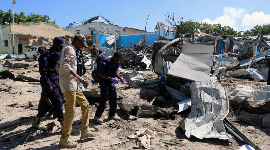 Click to enlarge Somali policemen assess the scene of an attack on a government building in Mogadishu