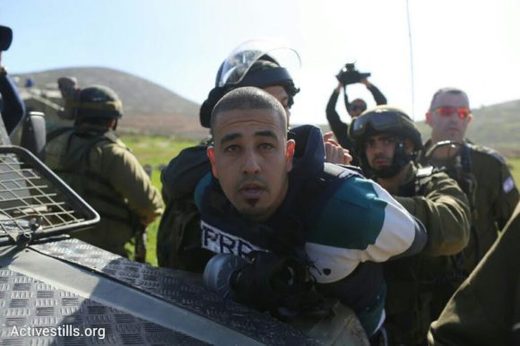 Click to enlarge Israeli troops detain Palestinian journalist