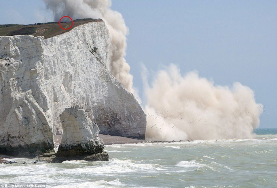 A sightseer was just feet away from death as 50,000 tons of chalk gave way and a cliff collapsed into the sea in East Sussex