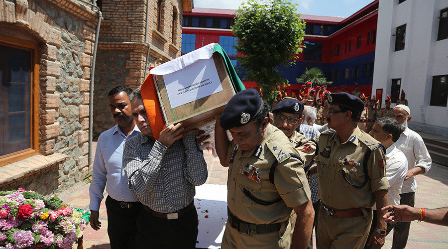 Indian police officers carry the coffin of their colleague at a police HQ in Srinagar, the summer capital of Indian-controlled Kashmir