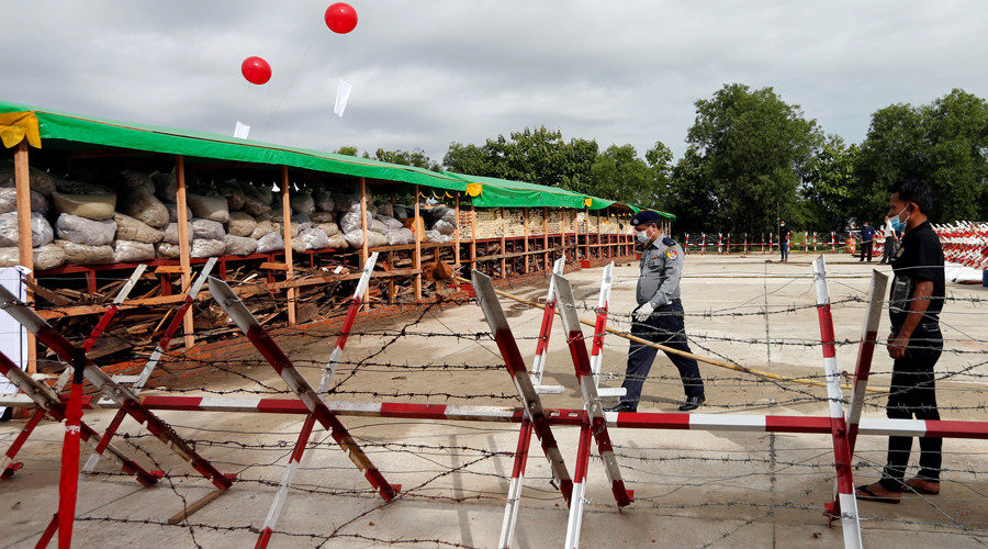 Click to enlarge Police officers prepare to destroy seized drugs outside Yangon, Myanmar
