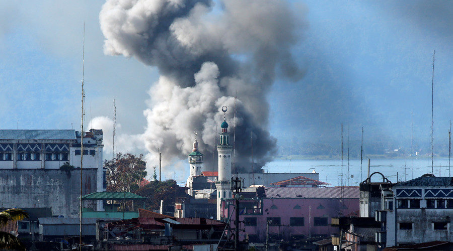 An explosion is seen after a Philippines army aircraft released a bomb during an airstrike in Marawi city