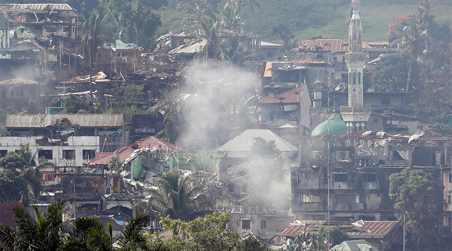 Smoke is seen while Philippines army troops continue their assault against insurgents from the Maute group in Marawi City