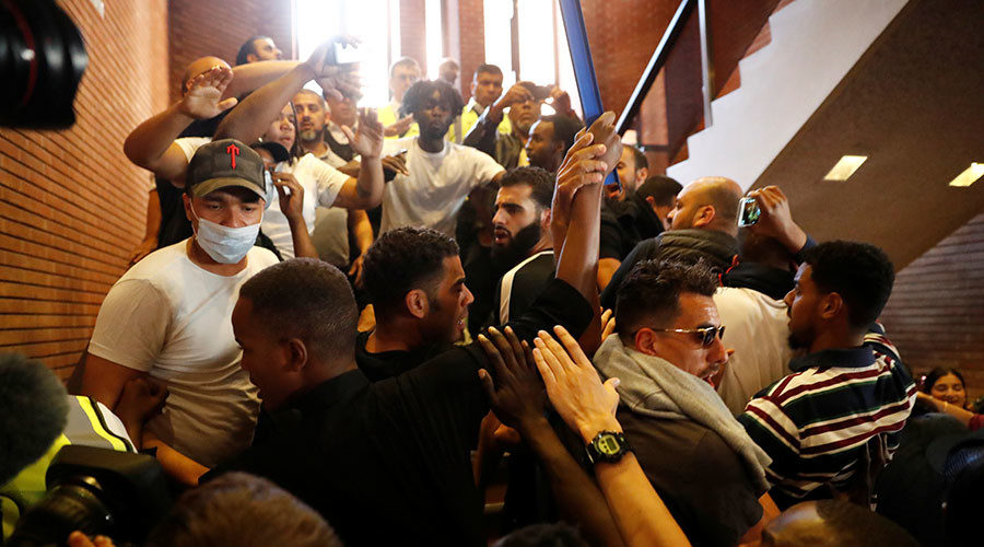 Click to enlarge Demonstrators crowd onto a staircase as they enter Kensington Town Hall