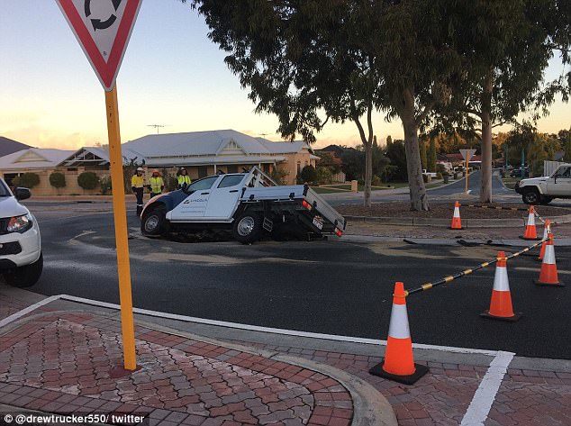 Click to enlarge A sinkhole swallowed his ute , forcing him to climb out the passenger side