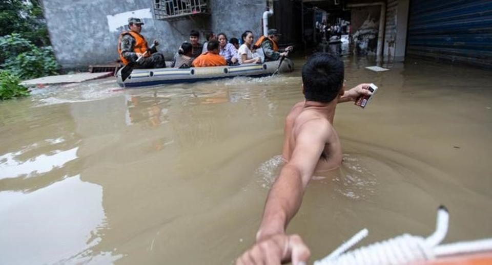 Rescuers row as they transfer residents with a boat at a flooded area in Guilin, Guangxi province, China on July 2.