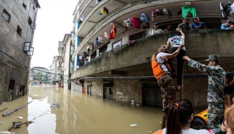 Rescuers transfer residents with a boat at a flooded area in Guilin, Guangxi province, China July 2, 2017.