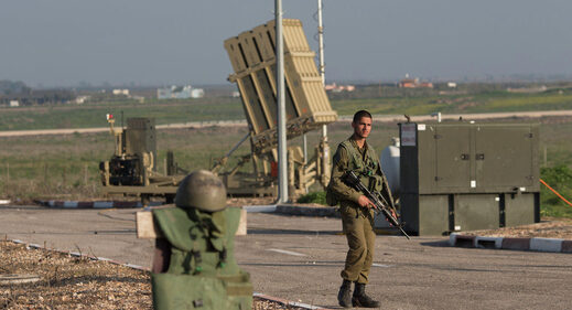 Israeli soldier guards Iron Dome system