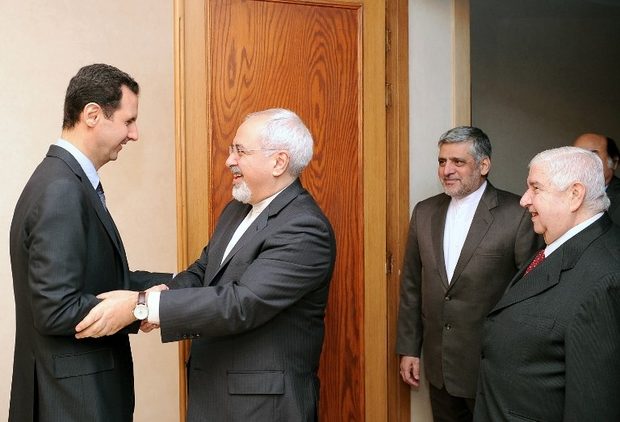 Bashar al-Assad greets Iranian Foreign Minister Mohammad Javad Zarif