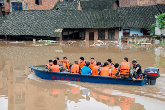 Rescuers evacuate people by boat during a flood in Xinshao county, Hunan province.