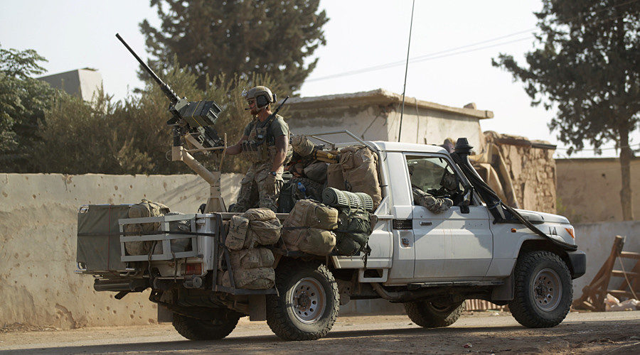 US soldiers ride a military vehicle in al-Kherbeh village, northern Aleppo province