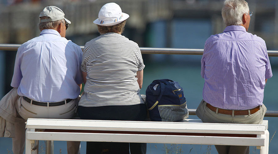 Click to enlarge Elderly vacationers on the Baltic Sea coast promenade in Kuehlungsborn, Germany