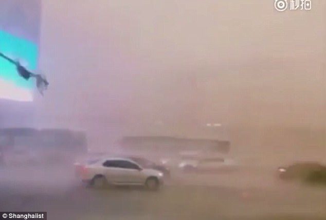 Car were pushed around by winds as the severe storm battered Chengdu, China, yesterday