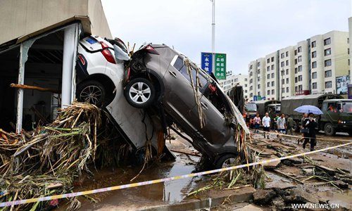 Click to enlarge Vehicles are damaged by flood water in Yongji County, northeast China's Jilin Province, July 14, 2017.