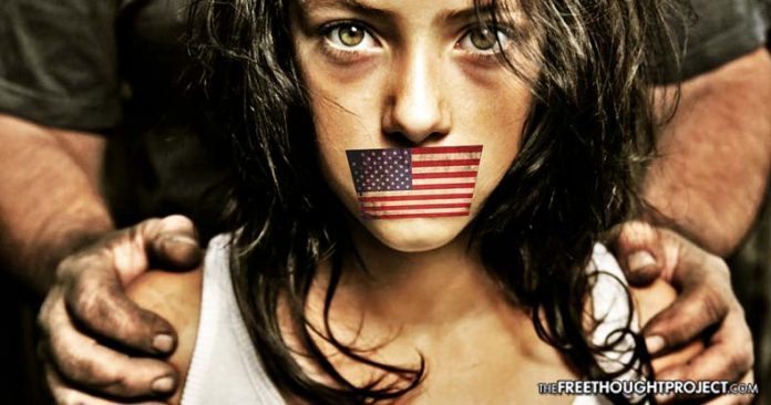 girl with US flag over mouth